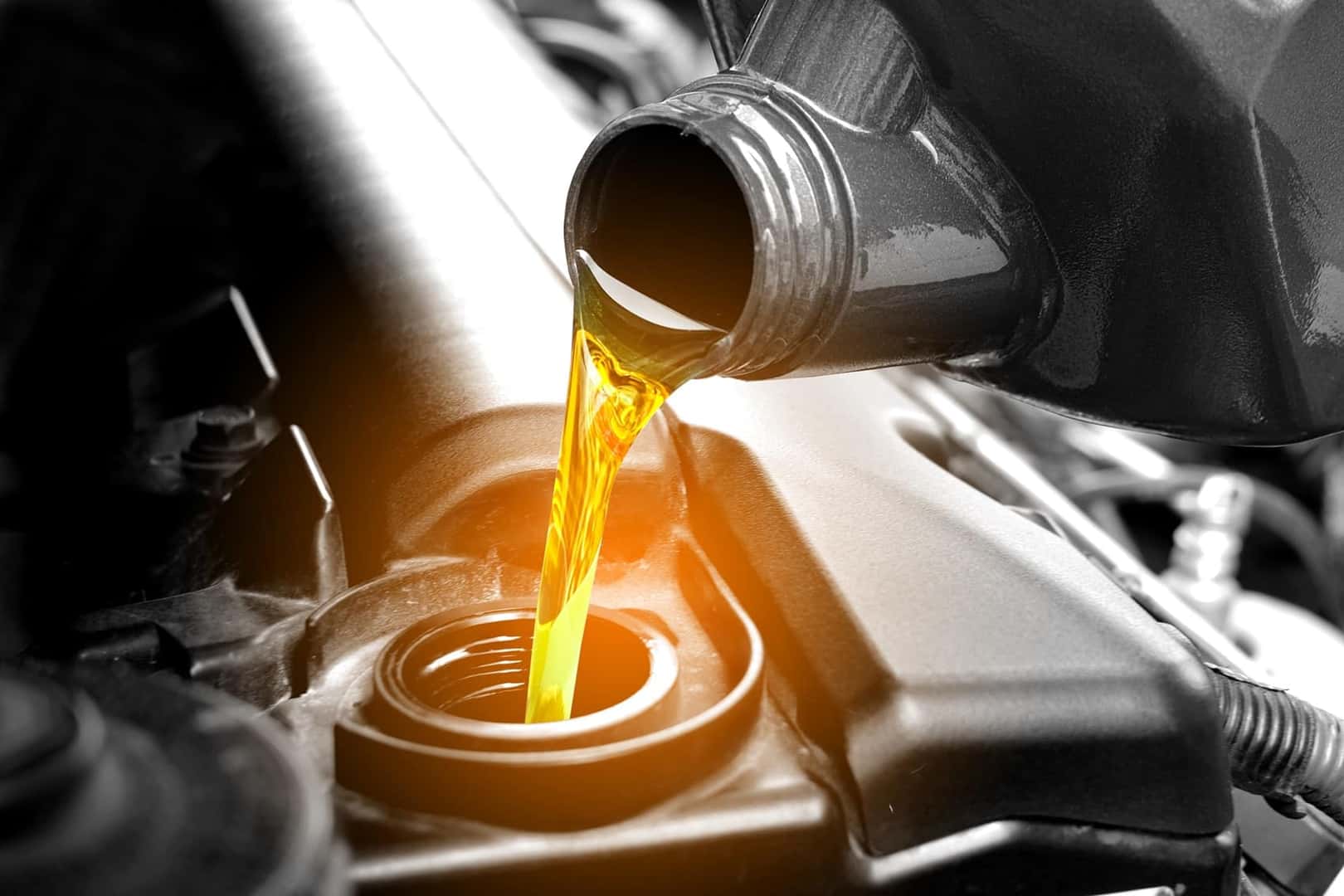 •	Acura technician performing an oil change