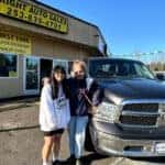 Happy customers with a newly purchased pre-owned car at All Rights Auto Sales