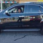 Smiling customer with her newly purchased car at All Right Auto Sale