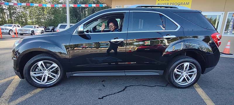 Smiling customer with her newly purchased car at All Right Auto Sale