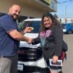 Happy customer completing a vehicle purchase at All Right Auto Sales
