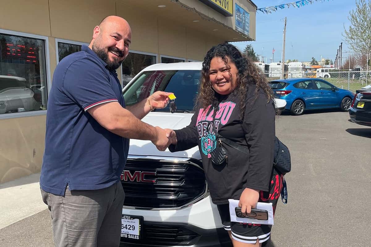 Happy customer completing a vehicle purchase at All Right Auto Sales