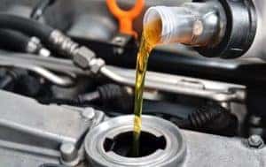 Mechanic pouring oil