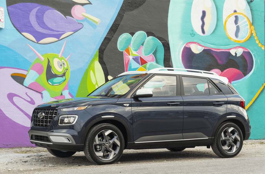 2026 Hyundai Venue in front of colorful wall.