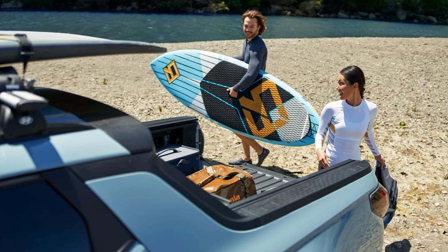 2026 Santa Cruz Owners retrieving their surfboards from the trunk to ride Hawaii waves
