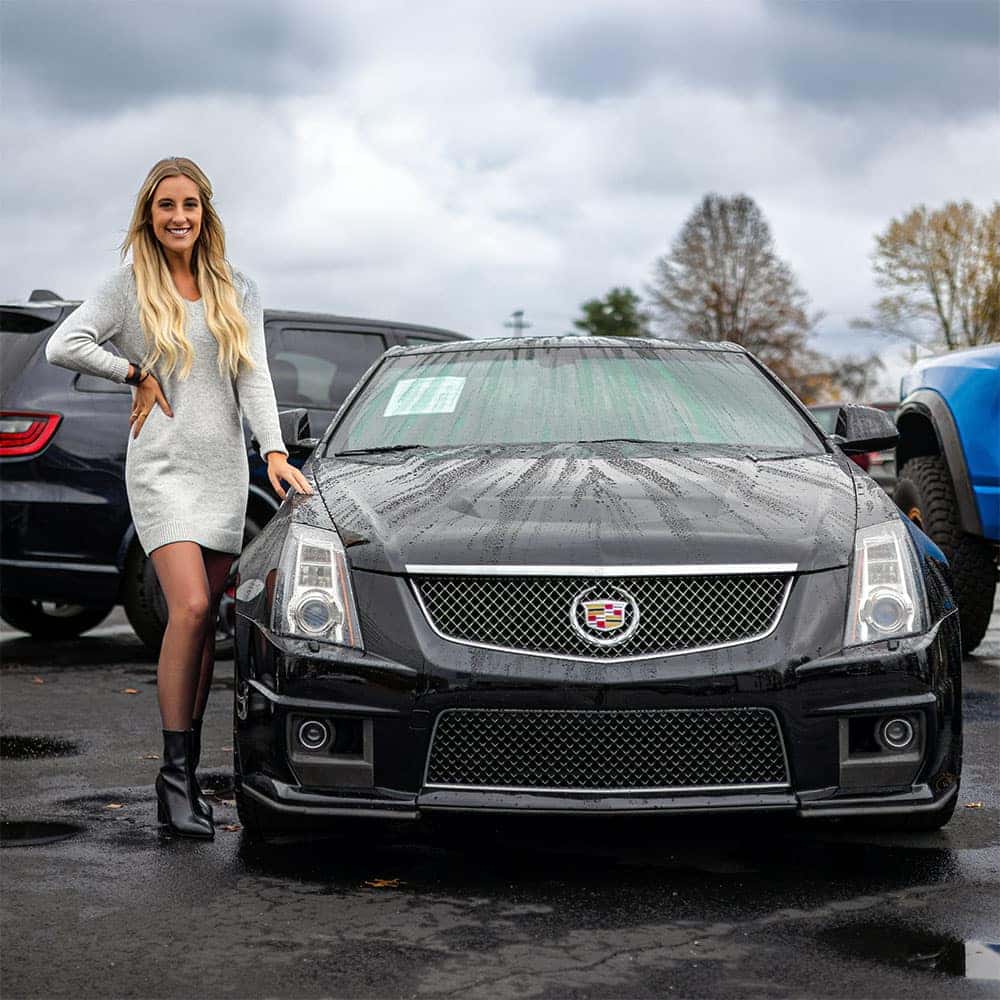 Bri Wagoner poses with a Cadillac