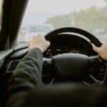 Man Steering a Car