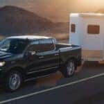 front exterior view of a 2026 chevy silverado 1500 towing a trailer