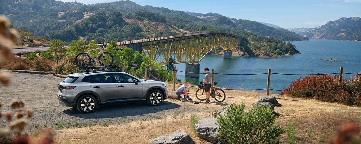 2024 Honda Prologue parked near a bridge with a bike on the roof rack