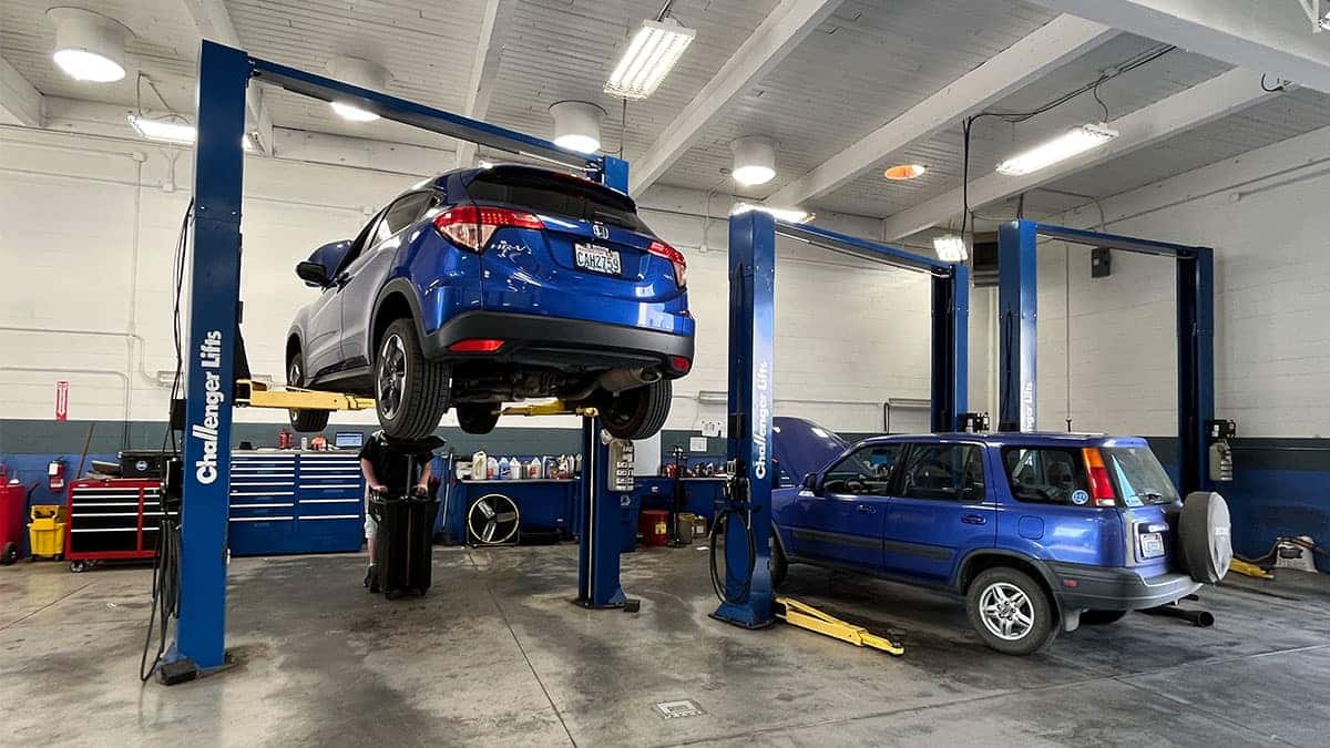 Honda service tech working on a Honda in the service bay