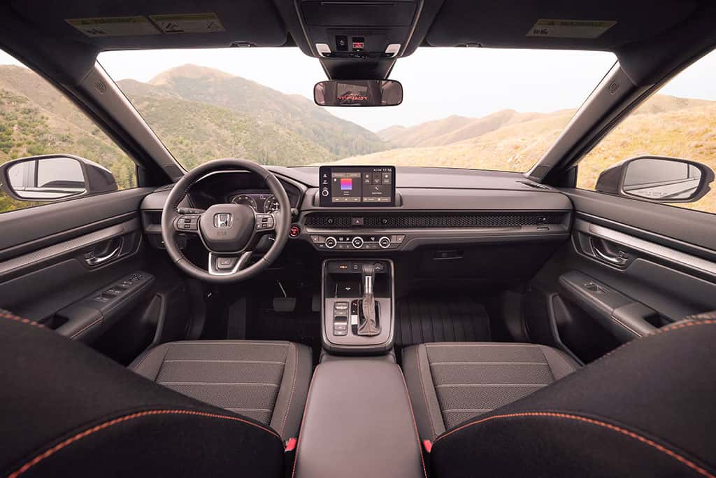 2026 Honda CR-V TrailSport Hybrid parked off-road showing interior and infotainment technology