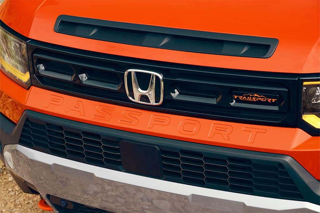 2026 Honda Passport TrailSport showing off front grill and fascia in sunset orange