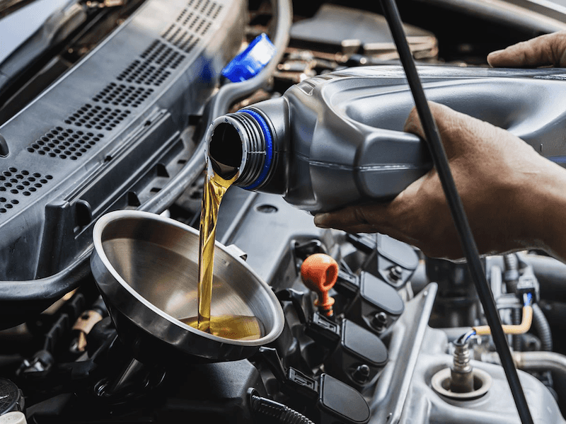 A mechanic performing an oil change at a preventative maintenance appointment