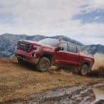 2021 Red GMC Sierra 1500 driving in mud