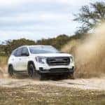 2022 GMC Terrain AT4 AWD in Summit White Driving through mud puddle