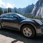 black chevy equinox driving through the mountains
