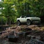 23 hummer ev pickup driving through a forest