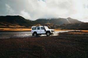 White Hummer car driving through water