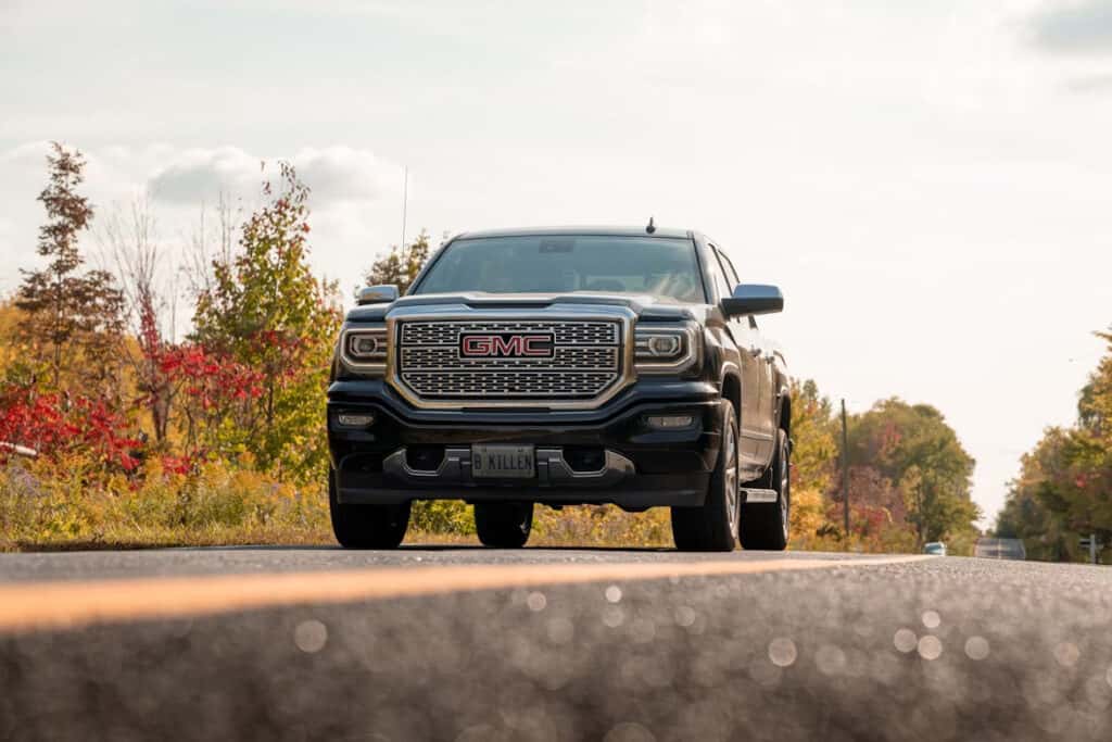 Black GMC on the road