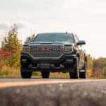 Black GMC on the road