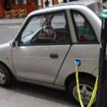 electric car charging at a charging station in city