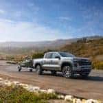 2023 Chevrolet Colorado z71 towing a jet ski on a dirt road