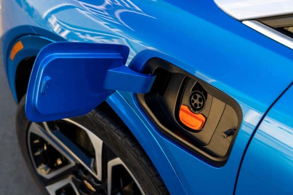 Close up of charge port on 2024 Chevrolet Equinox EV 3LT in Riptide Blue. Preproduction model shown. Actual production model may vary. 2024 Chevrolet Equinox EV available Fall 2023.