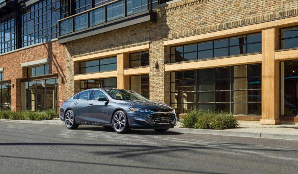 2021 Red Chevrolet Malibu Driving down a city street