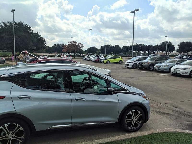 parking lot with an electric chevrolet bolt in the forefront