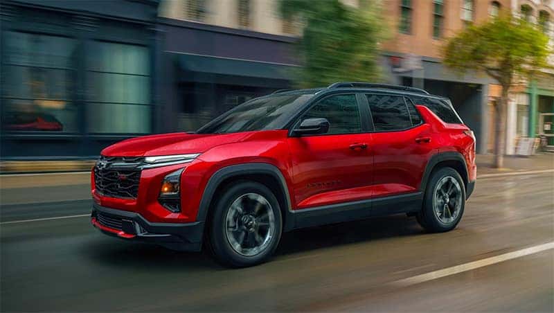 2026 Red Chevy Equinox driving in the city
