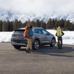 Car parked in front of snowy mountains