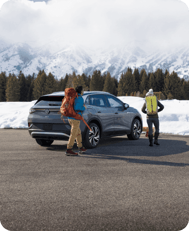 Car parked in front of snowy mountains
