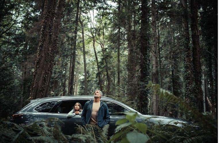 A man and young child in the woods with a 2020 Mazda CX-9 - El Dorado Mazda in McKinney, TX