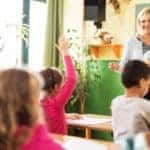 A female teach and young students in a classroom - El Dorado Mazda in McKinney, Texas
