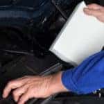 A man changing a car's air filter - El Dorado Mazda in McKinney, Texas