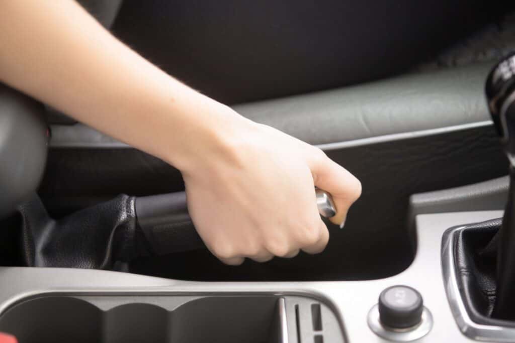 Hand holding handbrake