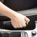 Hand holding handbrake