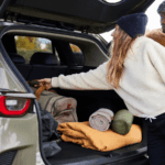 Couple reaching into the trunk of a Mazda CX-50