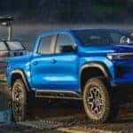 Front exterior view of a 2026 Chevrolet Colorado backing into a body of water to release a boat