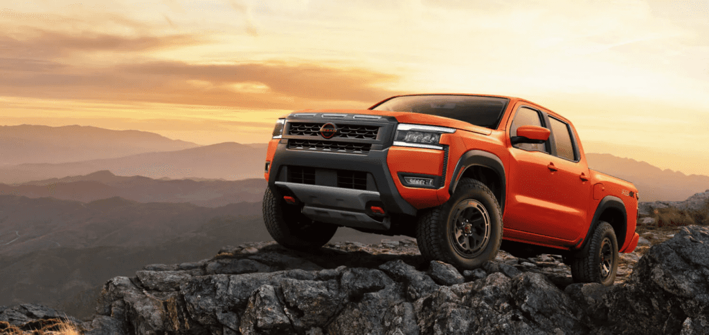 The 2026 Nissan Frontier climbing a rocky hill