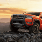 The 2026 Nissan Frontier climbing a rocky hill