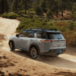 2025-nissan-pathfinder-rear-view-driving-down-dirt-mountain-road