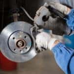 Technician performing brakes inspection and service