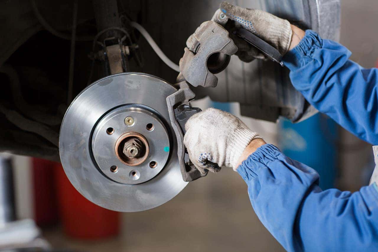 Technician performing brakes inspection and service