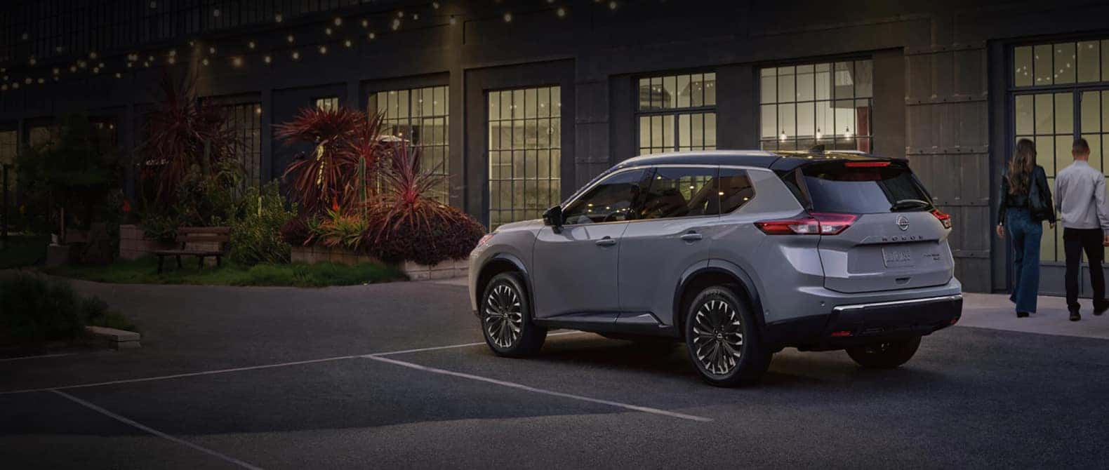 2026 Nissan Rogue parked outside a restaurant at dusk
