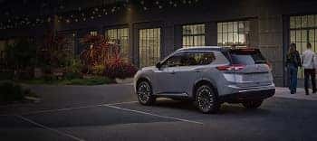 2026 Nissan Rogue parked outside a restaurant at dusk