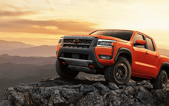Frontier PRO-4X parked on a rocky mountain ledge at sunset