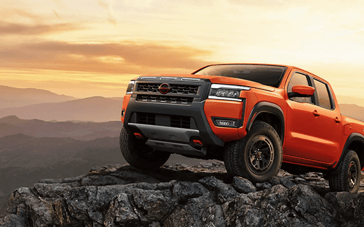 Frontier PRO-4X parked on a rocky mountain ledge at sunset
