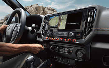 Driver using the 12.3-inch touchscreen Around View Monitor in the Frontier