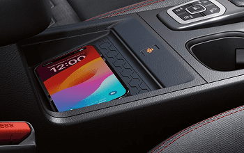 Smartphone on the wireless charging pad in the center console